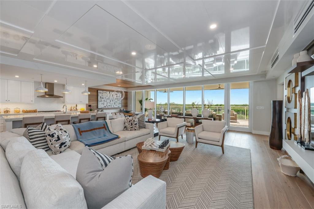 13925 Old Coast Road, Unit 403 Naples, FL 34110 - Photo 6 of 24 Living room with wood finished floors, recessed lighting, and a wall of windows