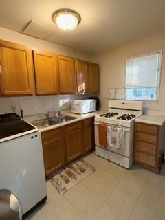 1625 Conley Road, Unit 21 Conley, GA 30288 - Photo 5 of 17 a kitchen with a stove sink and cabinets