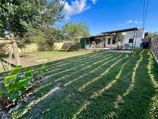 a view of a backyard with large trees