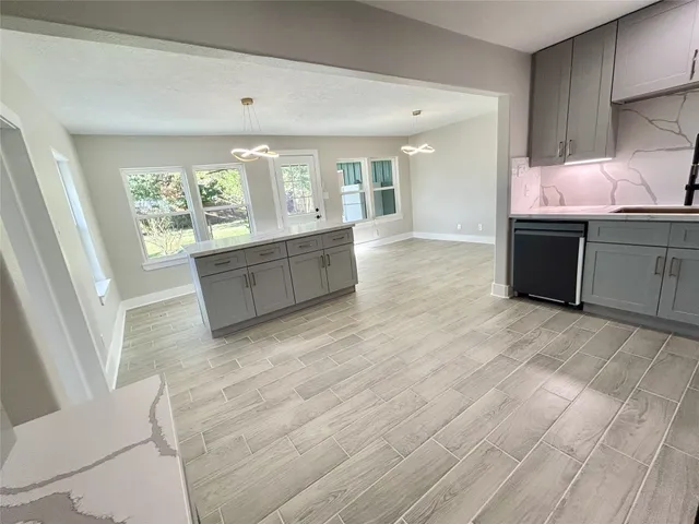 a large white kitchen with a large window