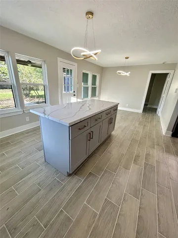 a spacious bathroom with a granite countertop sink a mirror and a window