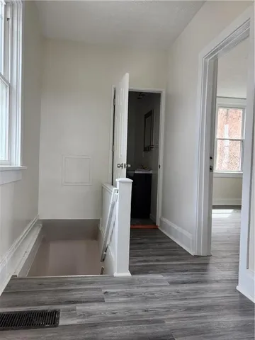 a view of entryway and hall with wooden floor