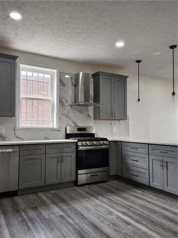 a kitchen with stainless steel appliances granite countertop a stove and a sink