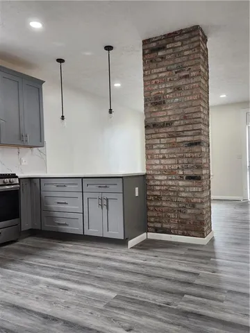 a kitchen with stainless steel appliances granite countertop a sink a stove and a refrigerator