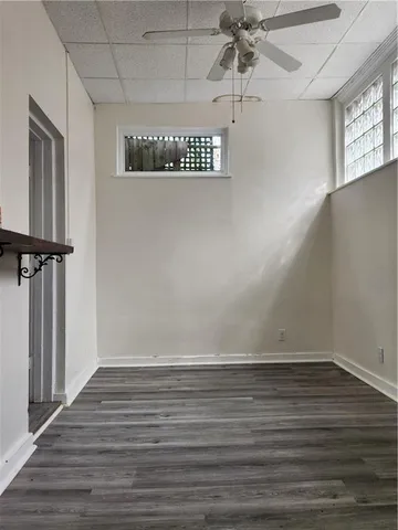 a view of a room with wooden floor and window