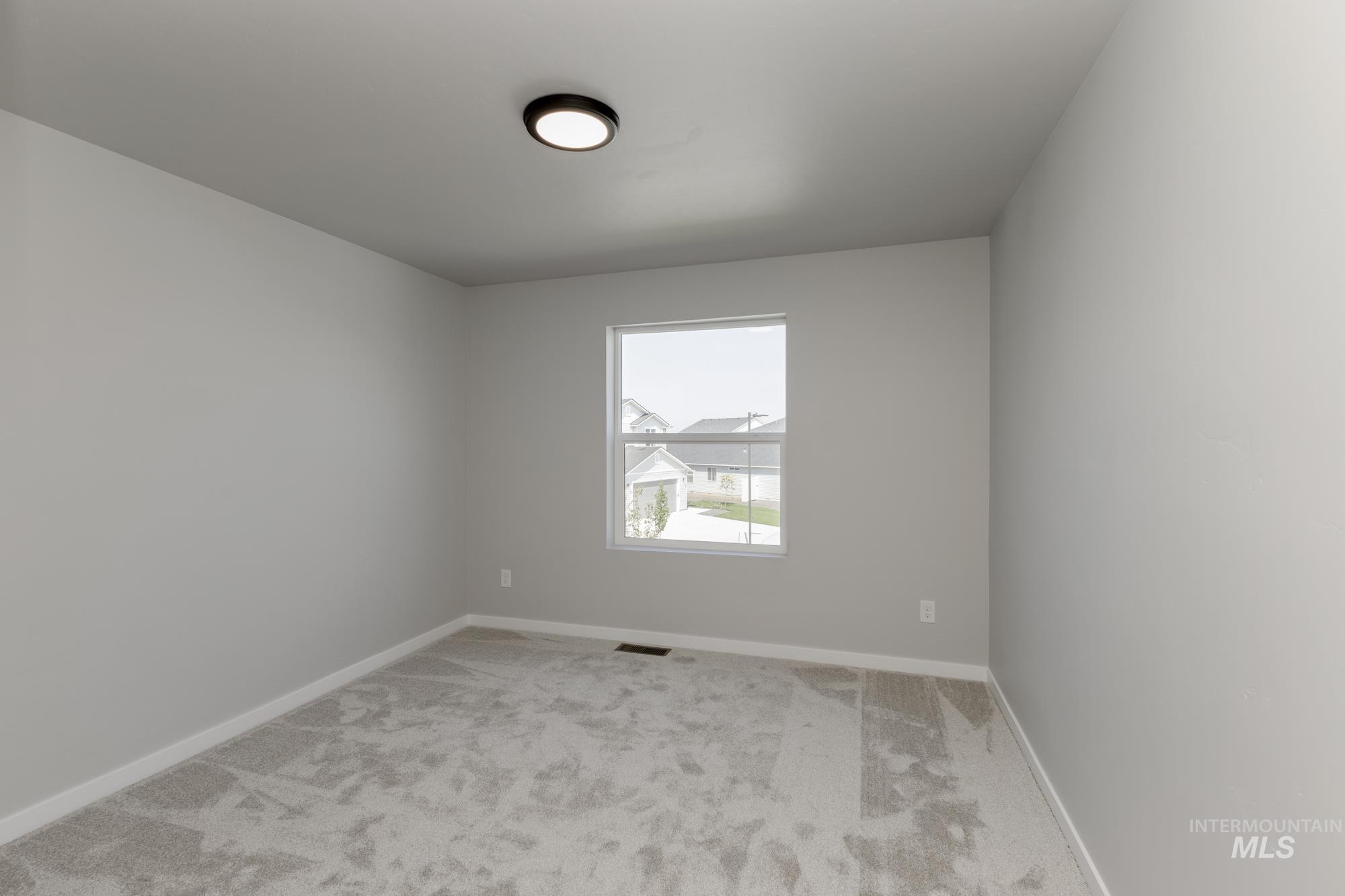 16262 Backfill Place Caldwell, ID 83607 - Photo 16 of 25 Spare room featuring light carpet and baseboards