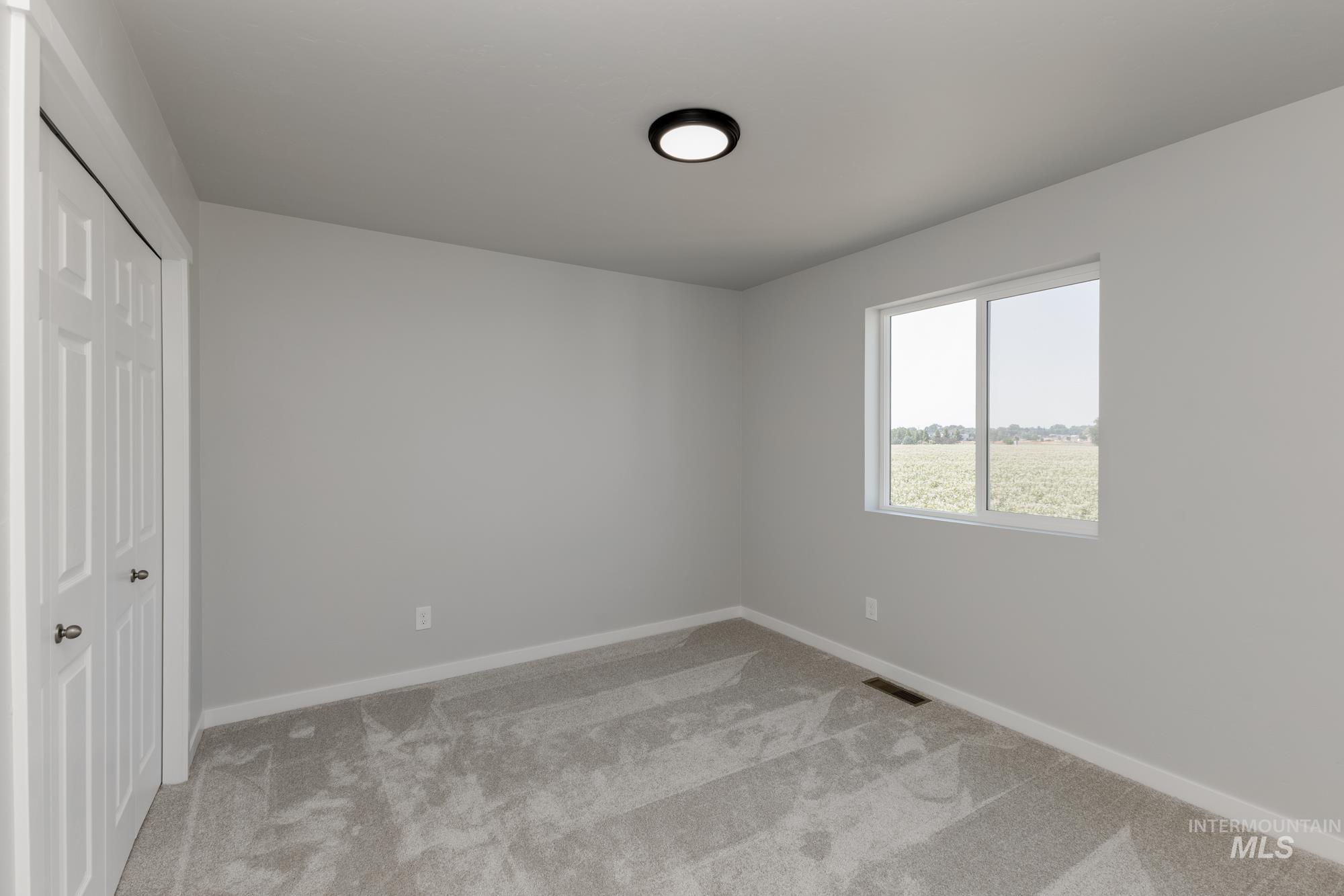 16262 Backfill Place Caldwell, ID 83607 - Photo 17 of 25 Unfurnished bedroom featuring light colored carpet and a closet