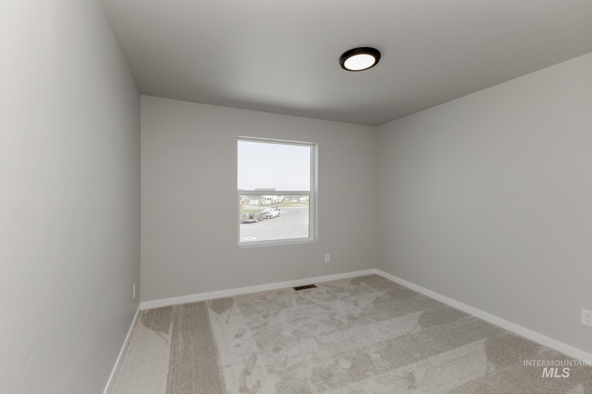 16262 Backfill Place Caldwell, ID 83607 - Photo 18 of 25 Empty room featuring light colored carpet and baseboards