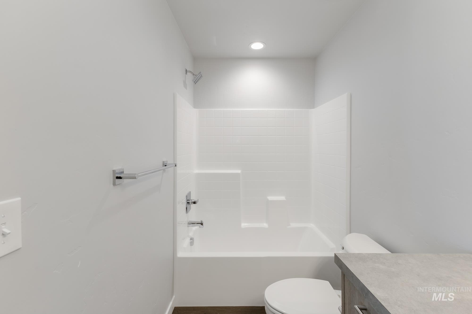 16262 Backfill Place Caldwell, ID 83607 - Photo 20 of 25 Full bathroom featuring vanity, bathing tub / shower combination, and dark wood-style flooring