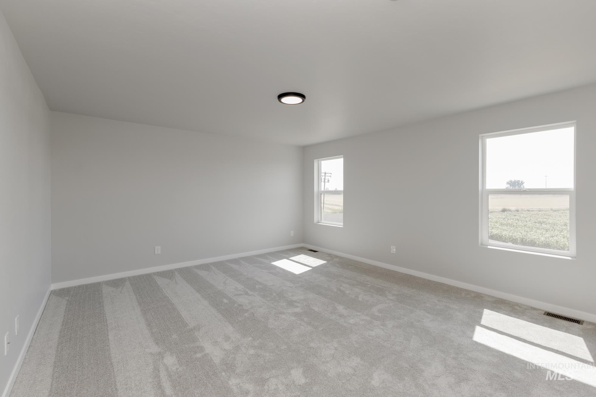 16262 Backfill Place Caldwell, ID 83607 - Photo 22 of 25 Empty room featuring carpet flooring and baseboards