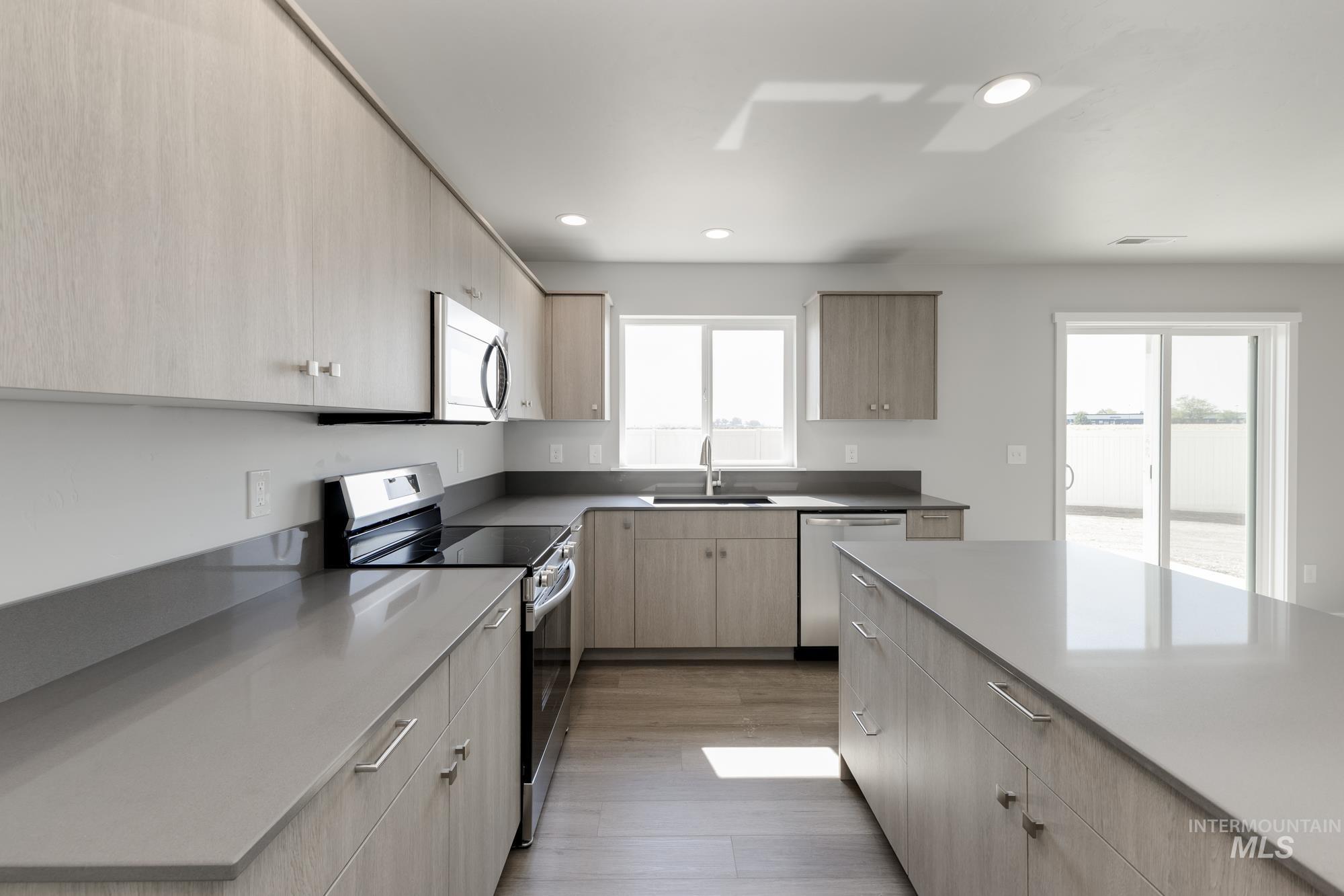 16262 Backfill Place Caldwell, ID 83607 - Photo 6 of 25 Kitchen featuring stainless steel appliances, light brown cabinets, light wood-style flooring, recessed lighting, and modern cabinets