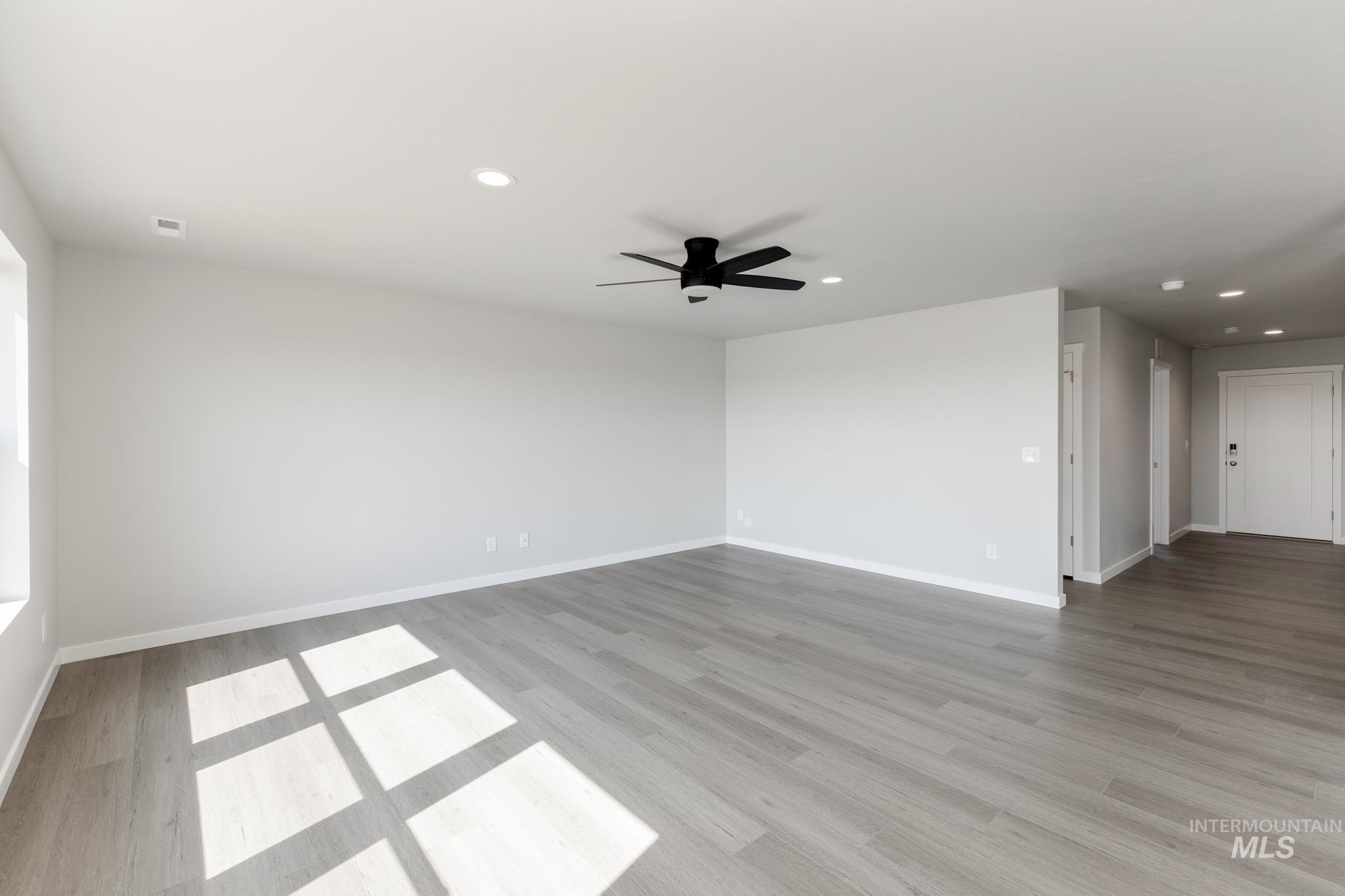16262 Backfill Place Caldwell, ID 83607 - Photo 10 of 25 Empty room featuring recessed lighting, light wood-style flooring, and ceiling fan