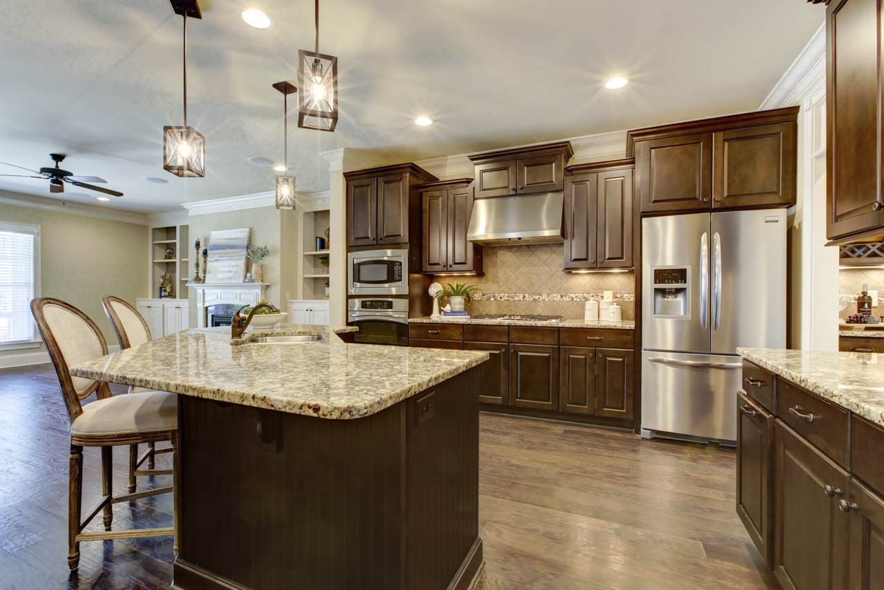 226 Penley Circle Raleigh, NC 27609 - Photo 3 of 14 The open Kitchen boasts GRANITE counter tops, built in SS appliances, under cabinet lighting, floor to ceiling gorgeous cabinetry, a pantry, and PLENTY of food prep space. There's no shortage of space here to hide away all of your cooking essentials. Chef's Kitchen