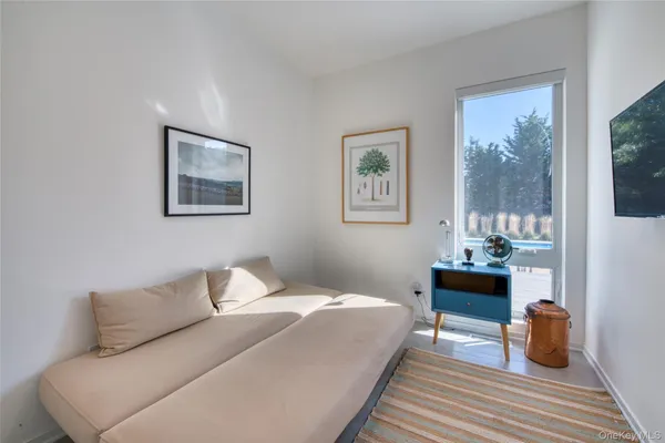 a bedroom with a bed and a painting on the wall