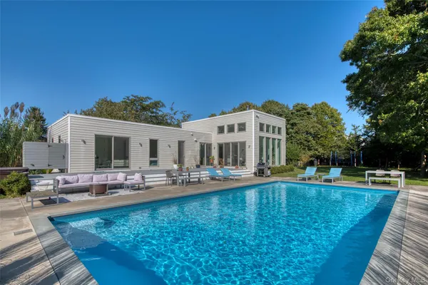 a view of a swimming pool with outdoor seating