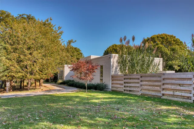 a view of a garden with large trees