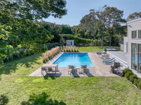 an aerial view of a house with swimming pool garden and patio