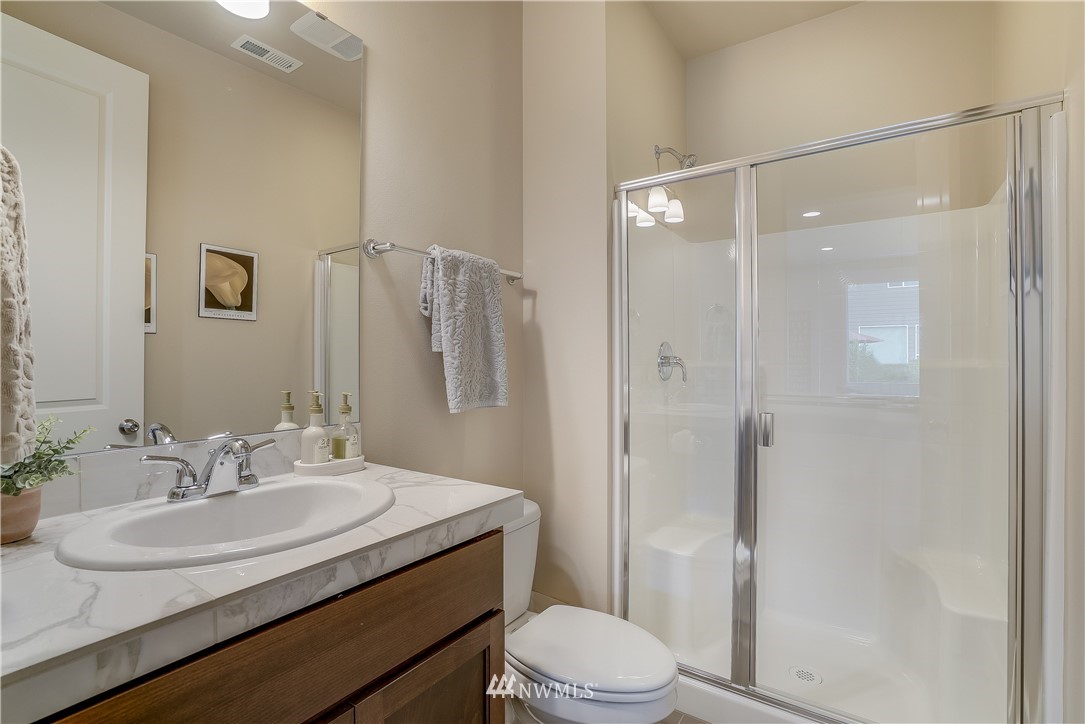 22104 38th Avenue Southeast Bothell, WA 98021 - Photo 22 of 24 a bathroom with a sink toilet and shower