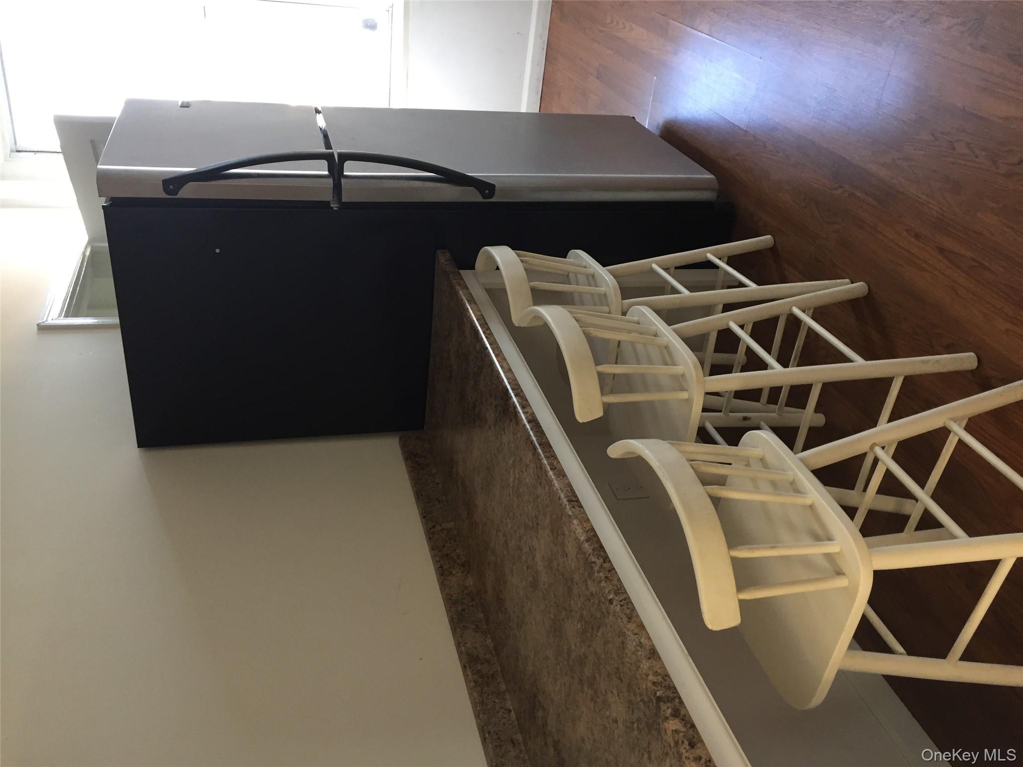 249 Main Street, Unit EAST Huntington, NY 11743 - Photo 5 of 11 a view of a chairs room with wooden floor