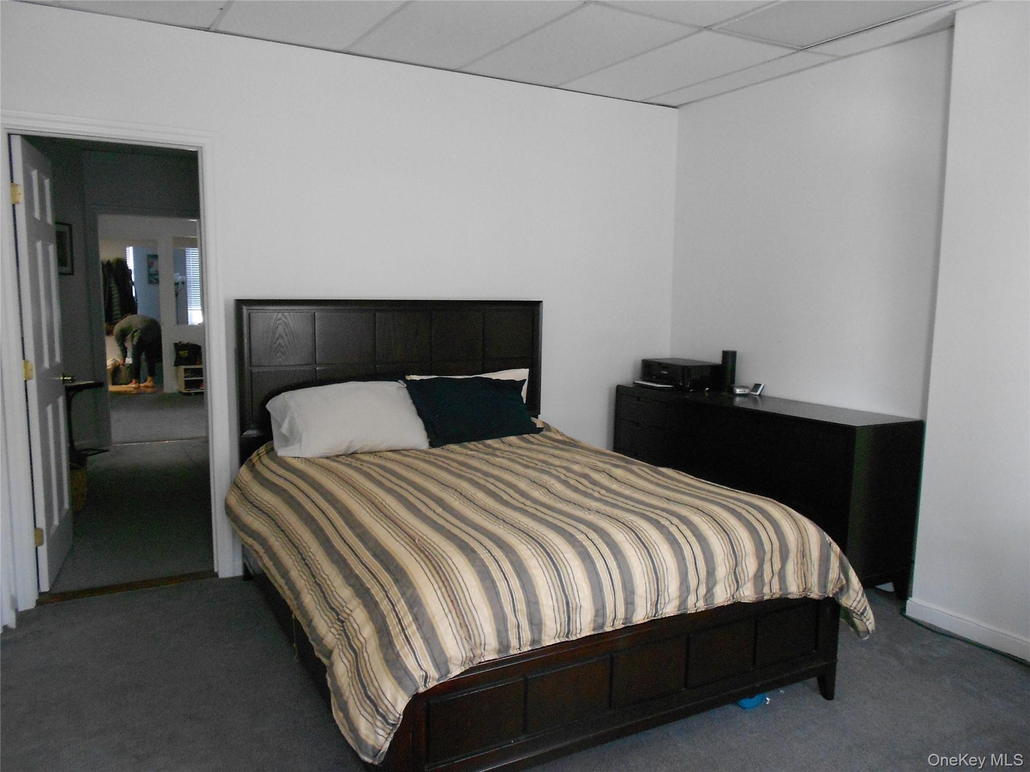 249 Main Street, Unit EAST Huntington, NY 11743 - Photo 8 of 11 a bedroom with a bed and closet