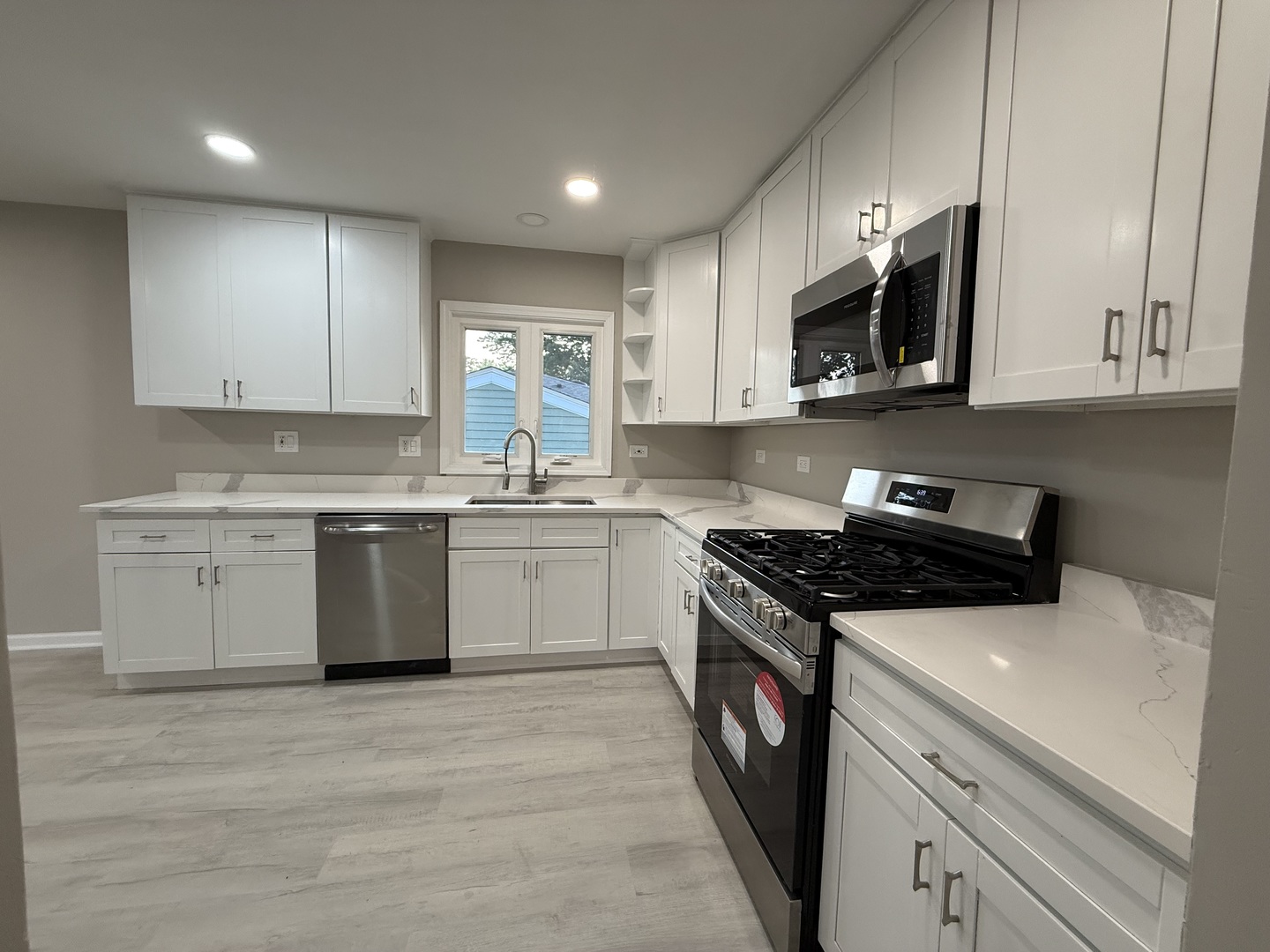 337 Woodland Drive Grayslake, IL 60030 - Photo 13 of 35 a kitchen with stainless steel appliances granite countertop a stove a sink and a microwave