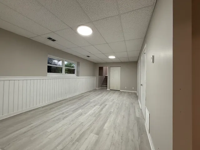 a view of empty room with wooden floor