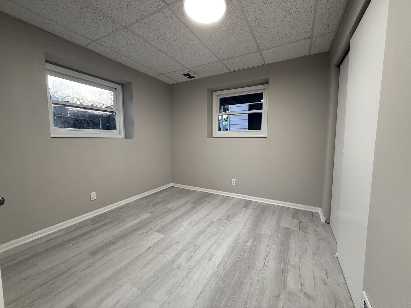 337 Woodland Drive Grayslake, IL 60030 - Photo 22 of 35 a view of an empty room with wooden floor and a window