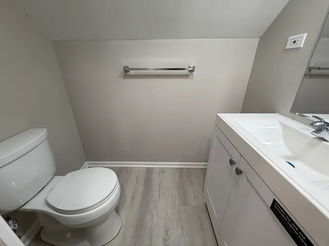 a white toilet sitting next to a bathroom sink
