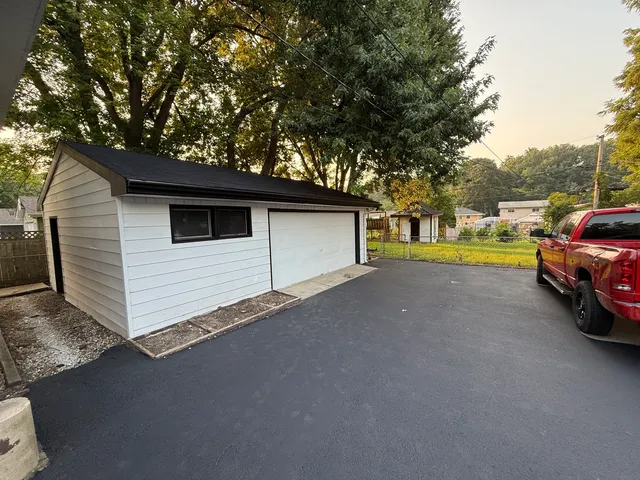 a view of a house with a yard and garage