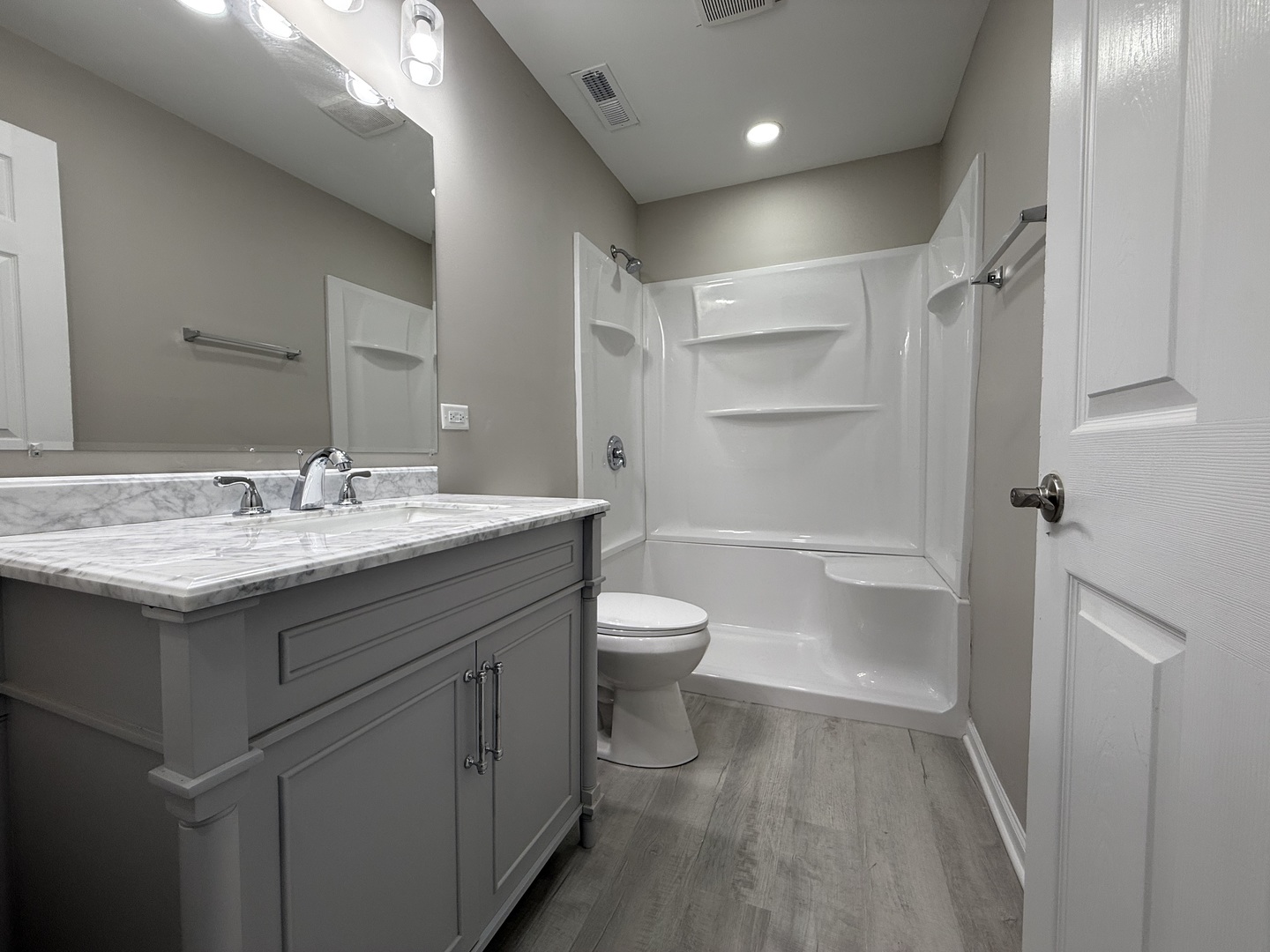 337 Woodland Drive Grayslake, IL 60030 - Photo 8 of 35 a bathroom with a granite countertop sink a toilet and shower