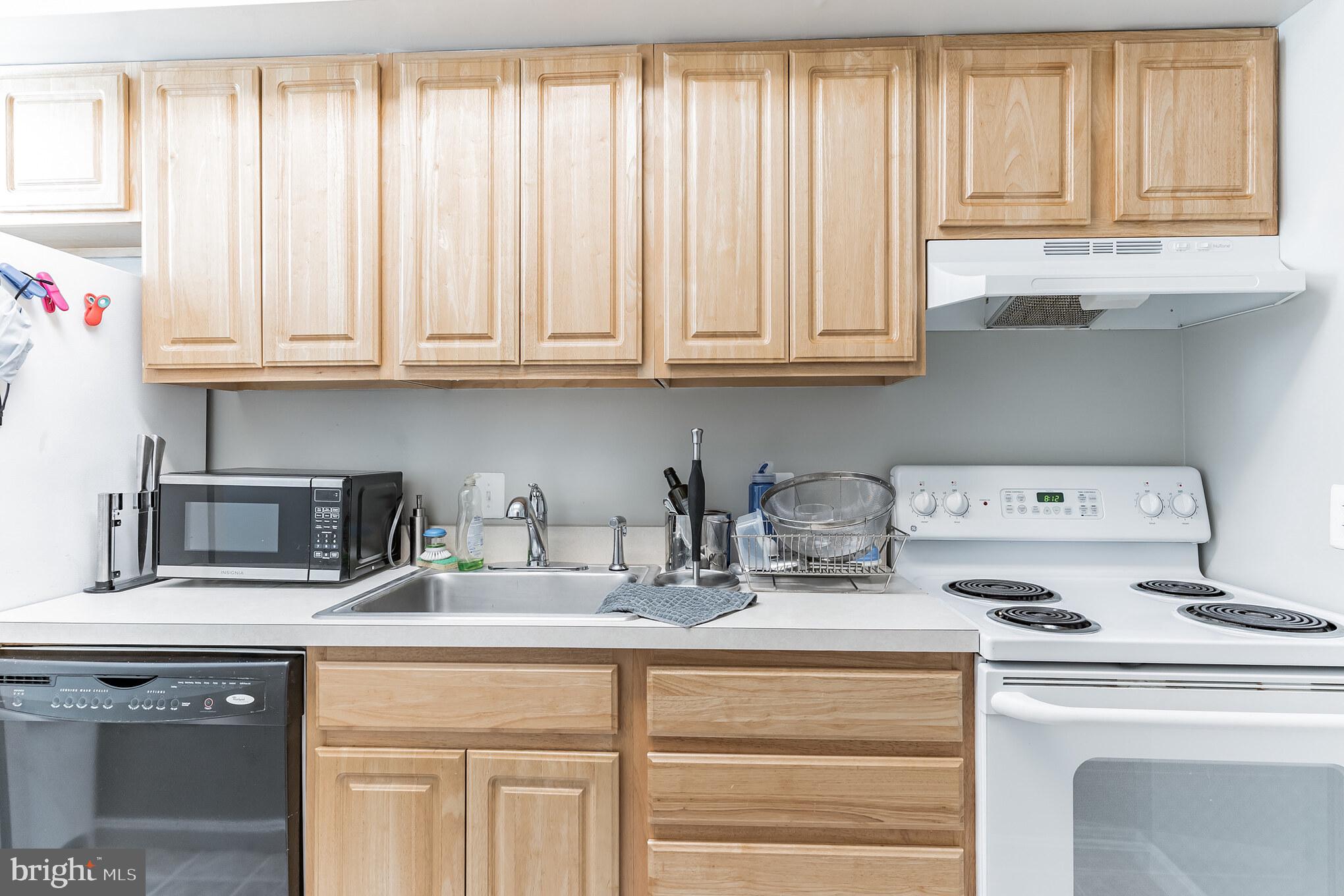 1208 1/2 33rd Street Northwest Washington, DC 20007 - Photo 12 of 30 a kitchen with appliances cabinets and a window