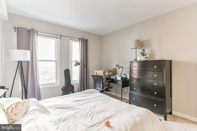 a bedroom with a bed and a dresser