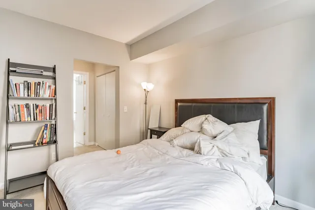 a large bed with a bed and a book shelf
