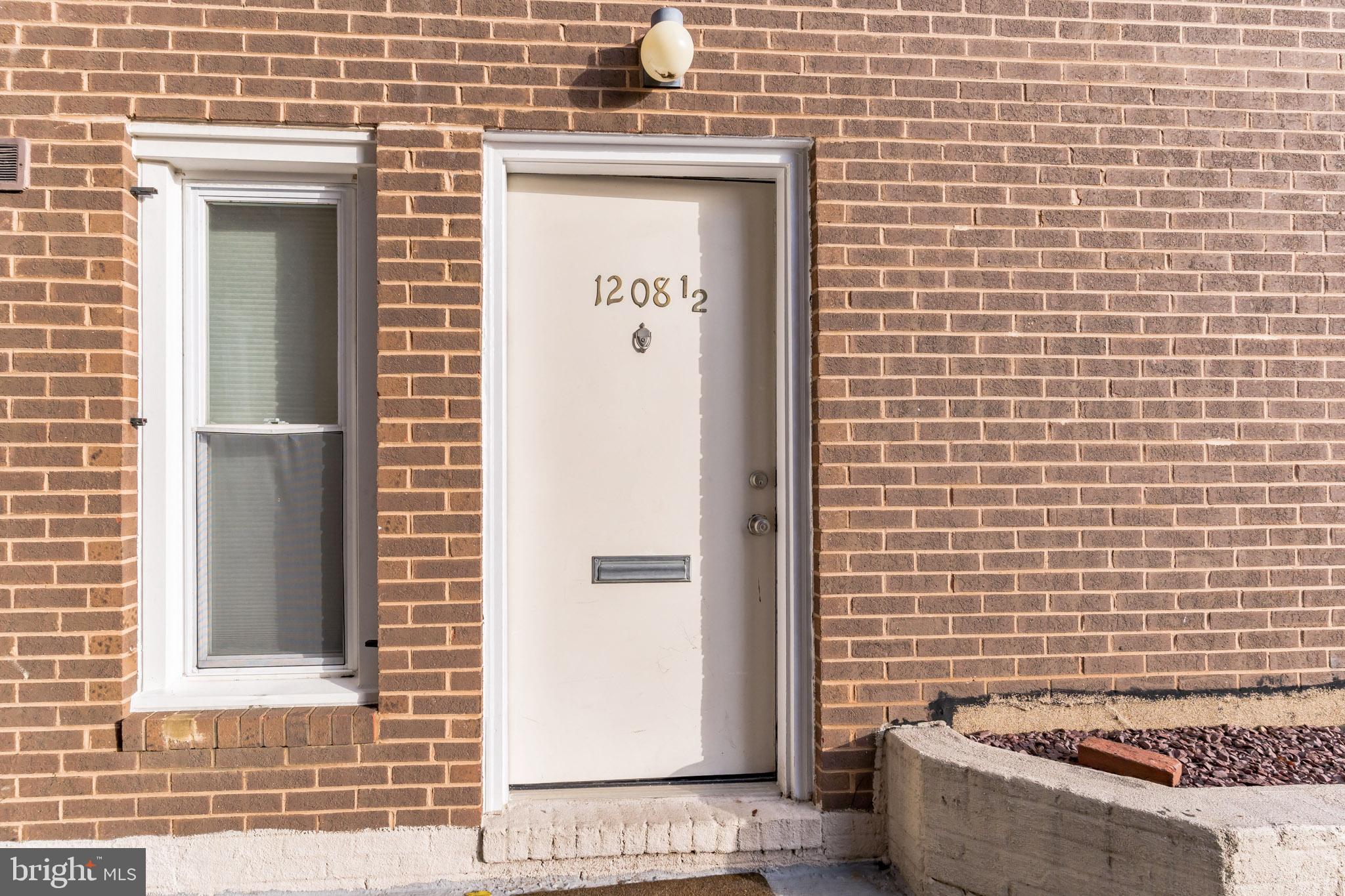 1208 1/2 33rd Street Northwest Washington, DC 20007 - Photo 4 of 30 a view of a door with a bench
