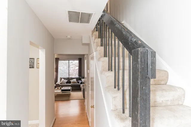 a view of a hallway with furniture and staircase