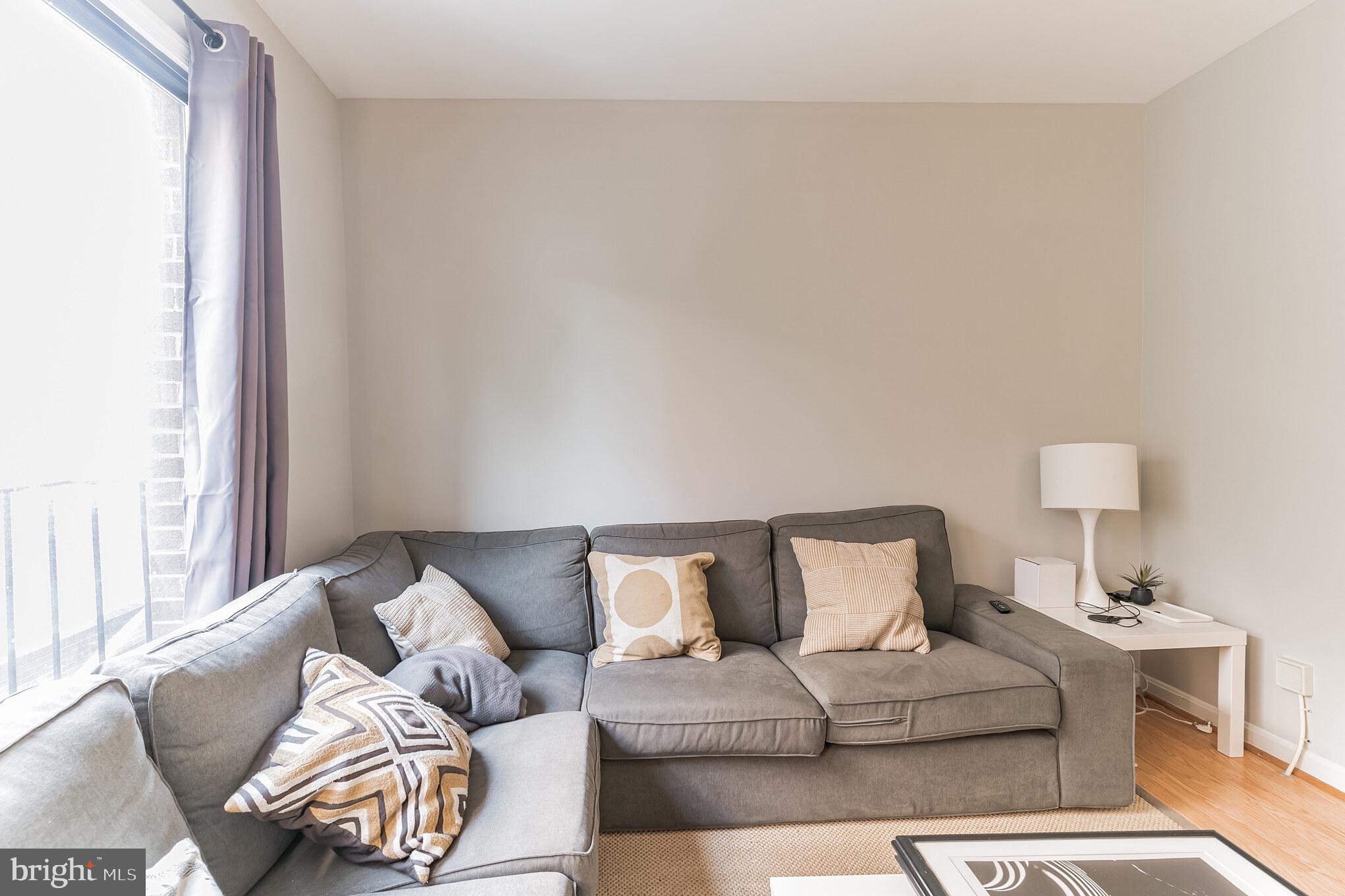 1208 1/2 33rd Street Northwest Washington, DC 20007 - Photo 6 of 30 a living room with furniture and a lamp