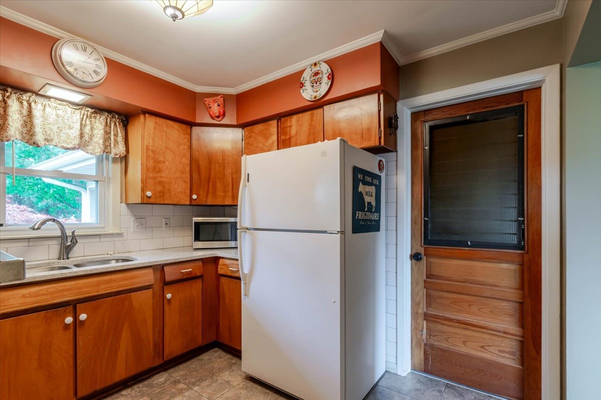 302 Radliff Road Bloomington, IL 61701 - Photo 11 of 35 a white refrigerator freezer sitting inside of a kitchen