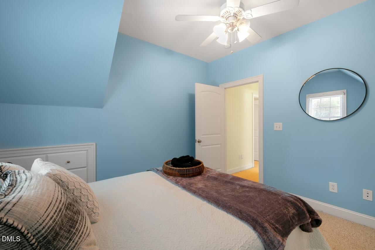 9199 Fox Run Road Bailey, NC 27807 - Photo 17 of 36 a bedroom with a bed and a chandelier