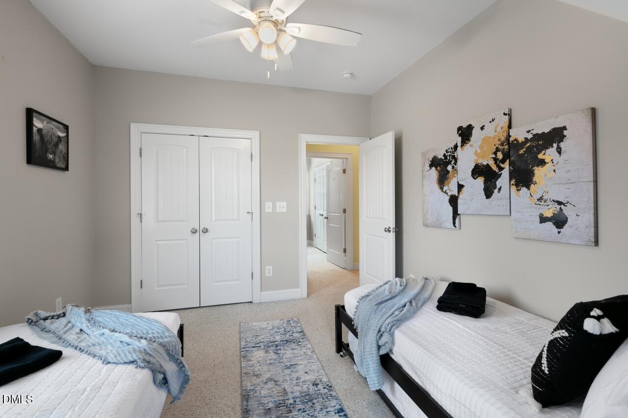 9199 Fox Run Road Bailey, NC 27807 - Photo 19 of 36 a bedroom with a bed and a chandelier