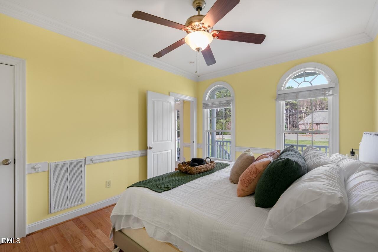 9199 Fox Run Road Bailey, NC 27807 - Photo 23 of 36 a bedroom with a bed and a chandelier