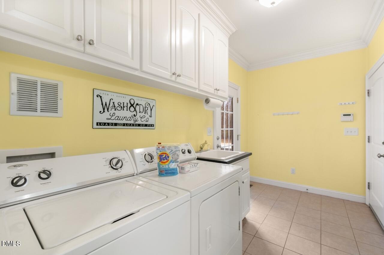 9199 Fox Run Road Bailey, NC 27807 - Photo 29 of 36 a view of a storage and utility room with washer and dryer