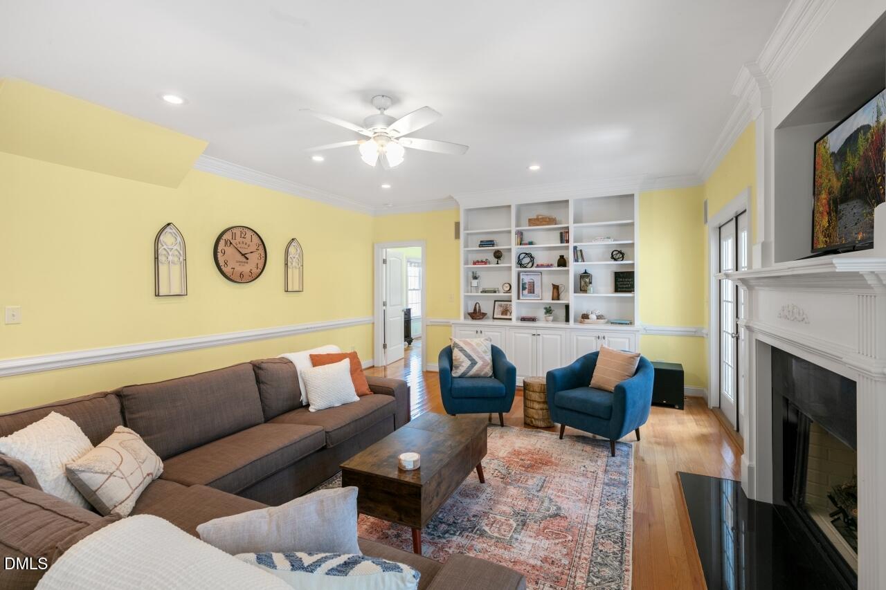 9199 Fox Run Road Bailey, NC 27807 - Photo 32 of 36 a living room with furniture flat screen tv and a fireplace