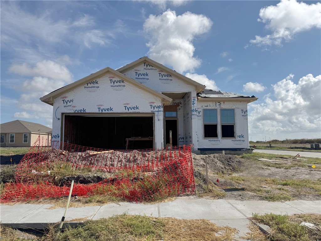 a view of a house with wooden fence