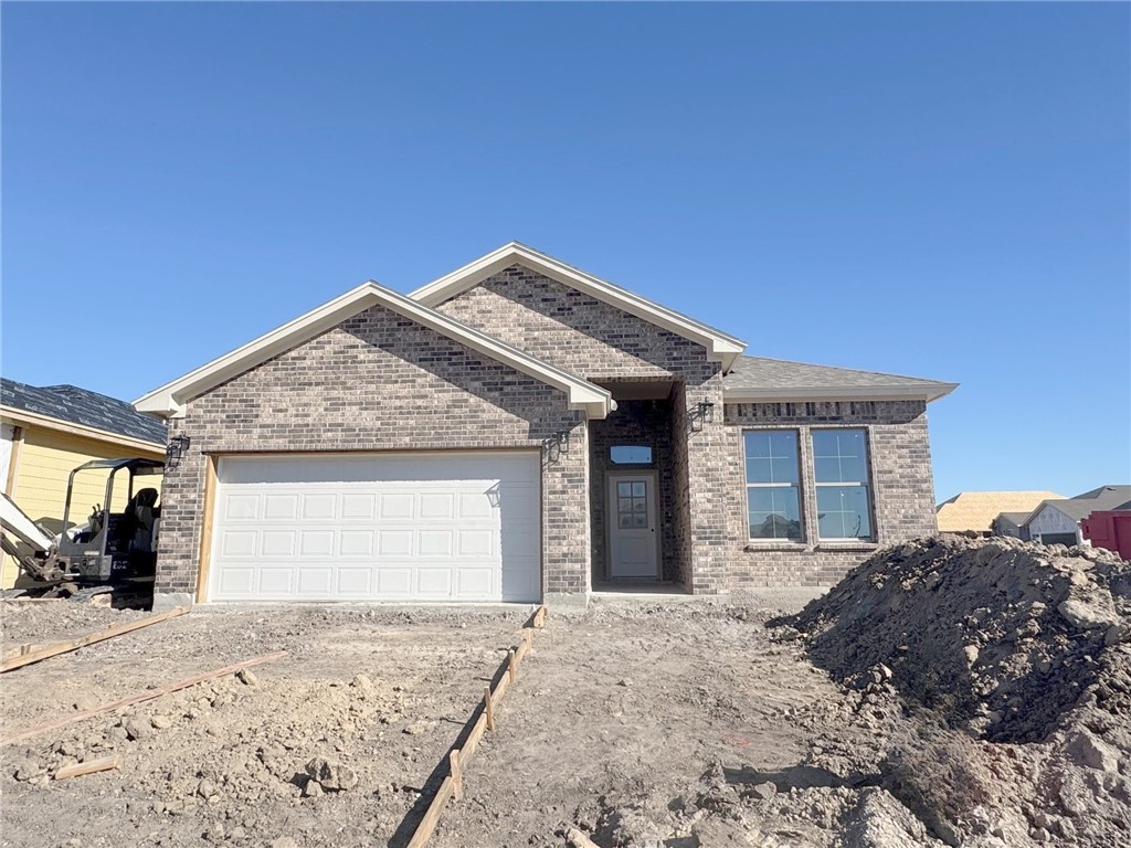 a front view of house with a garden