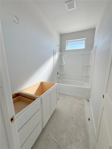 a bathroom with a tub and shower