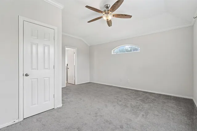 an empty room with closet and a chandelier fan