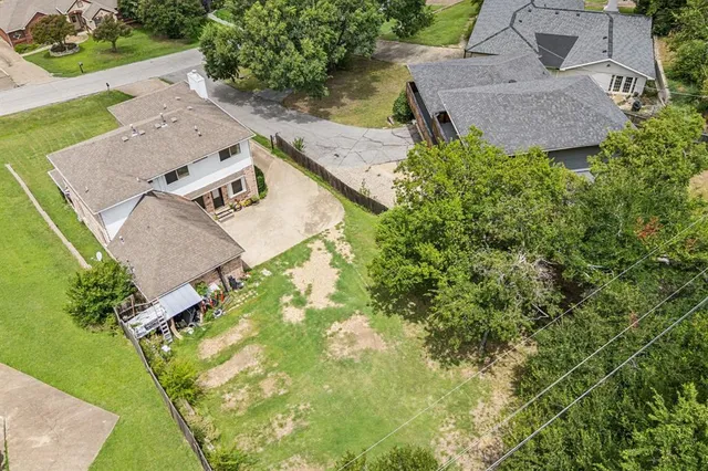 an aerial view of a house with yard and outdoor seating
