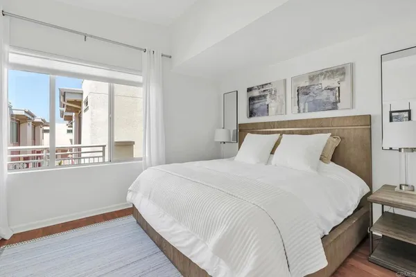 a bedroom with a large bed and a window