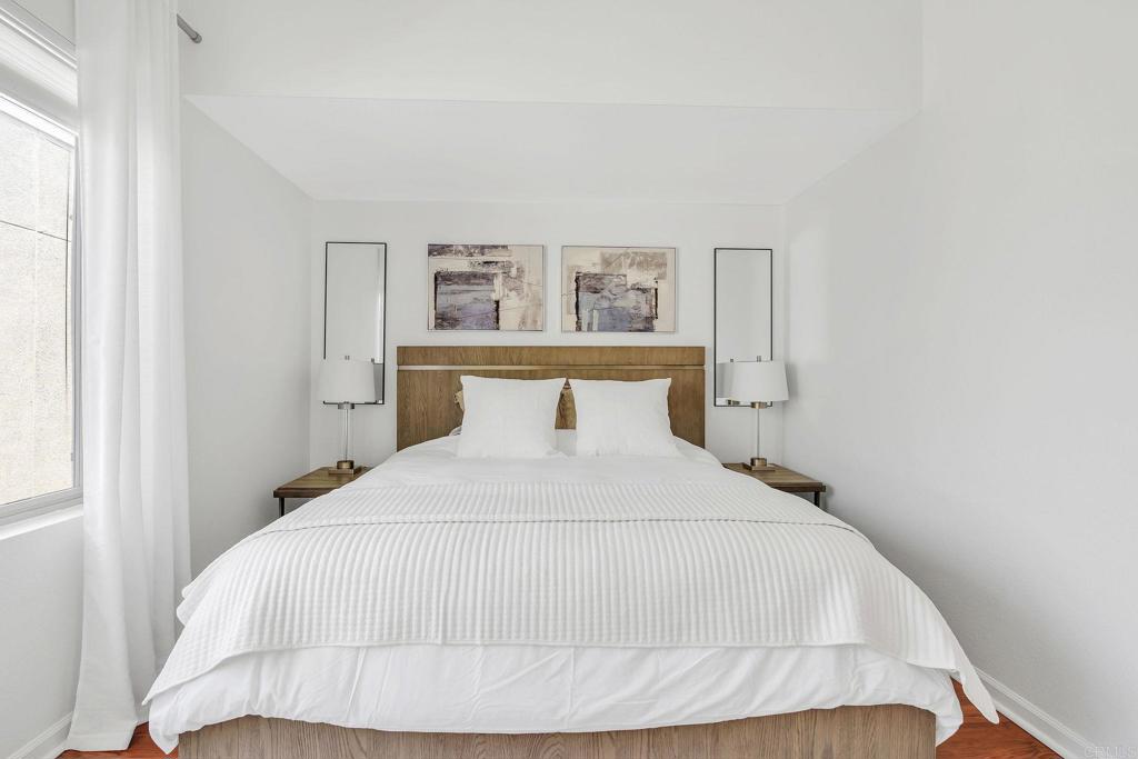 687 South Coast Highway 101, Unit 302 Encinitas, CA 92024 - Photo 14 of 32 a bedroom with a bed and window