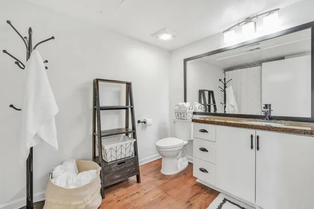 a bathroom with a toilet a sink and a mirror